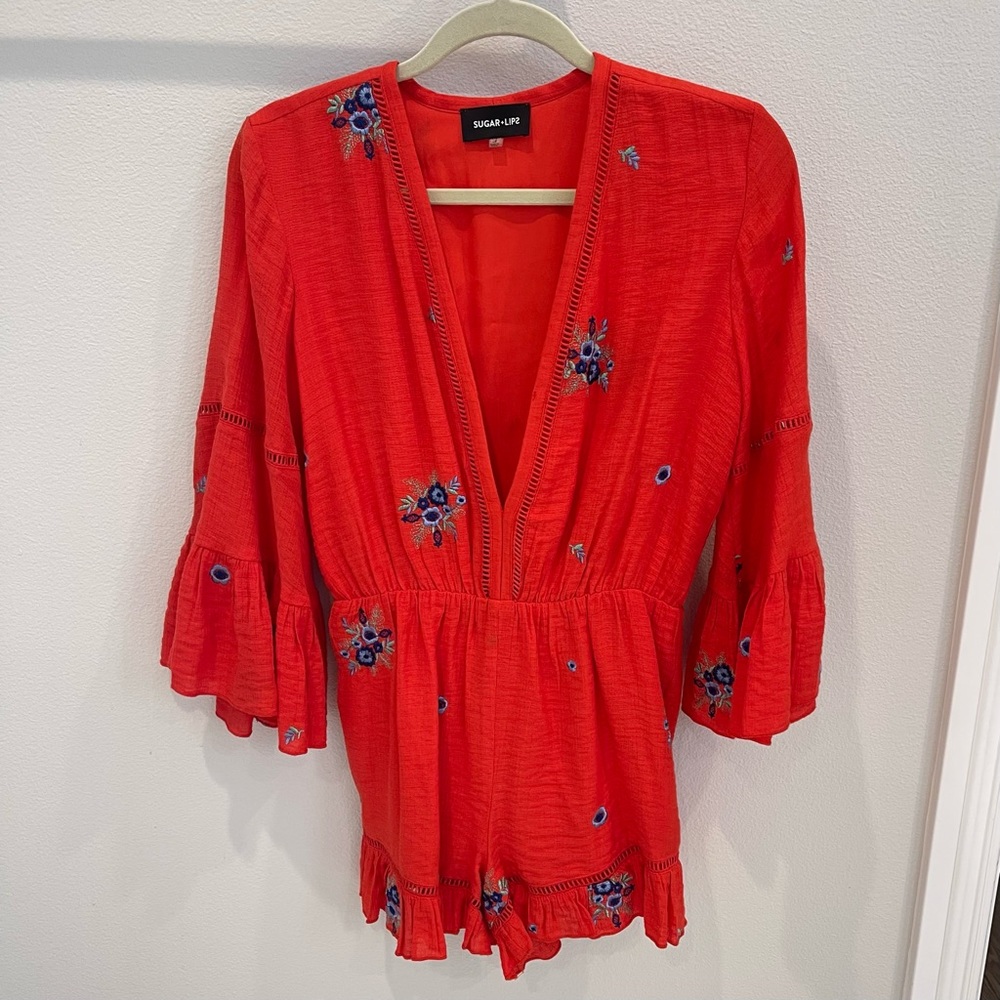 Red romper with flower detail